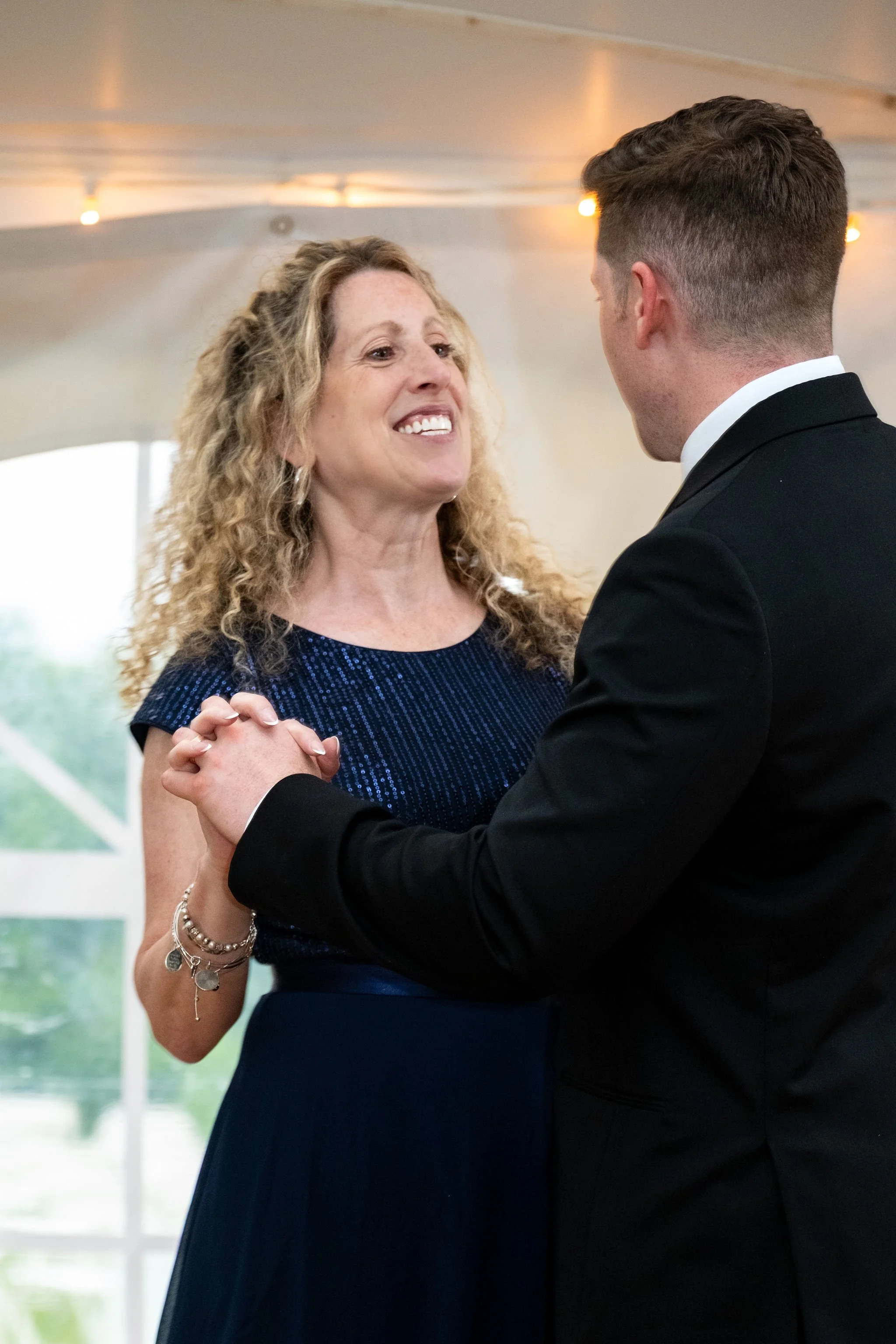 Ethan DeAngelis dancing with his mother inside the reception tent at their Sanbornton New Hampshire wedding photography VMG Productions