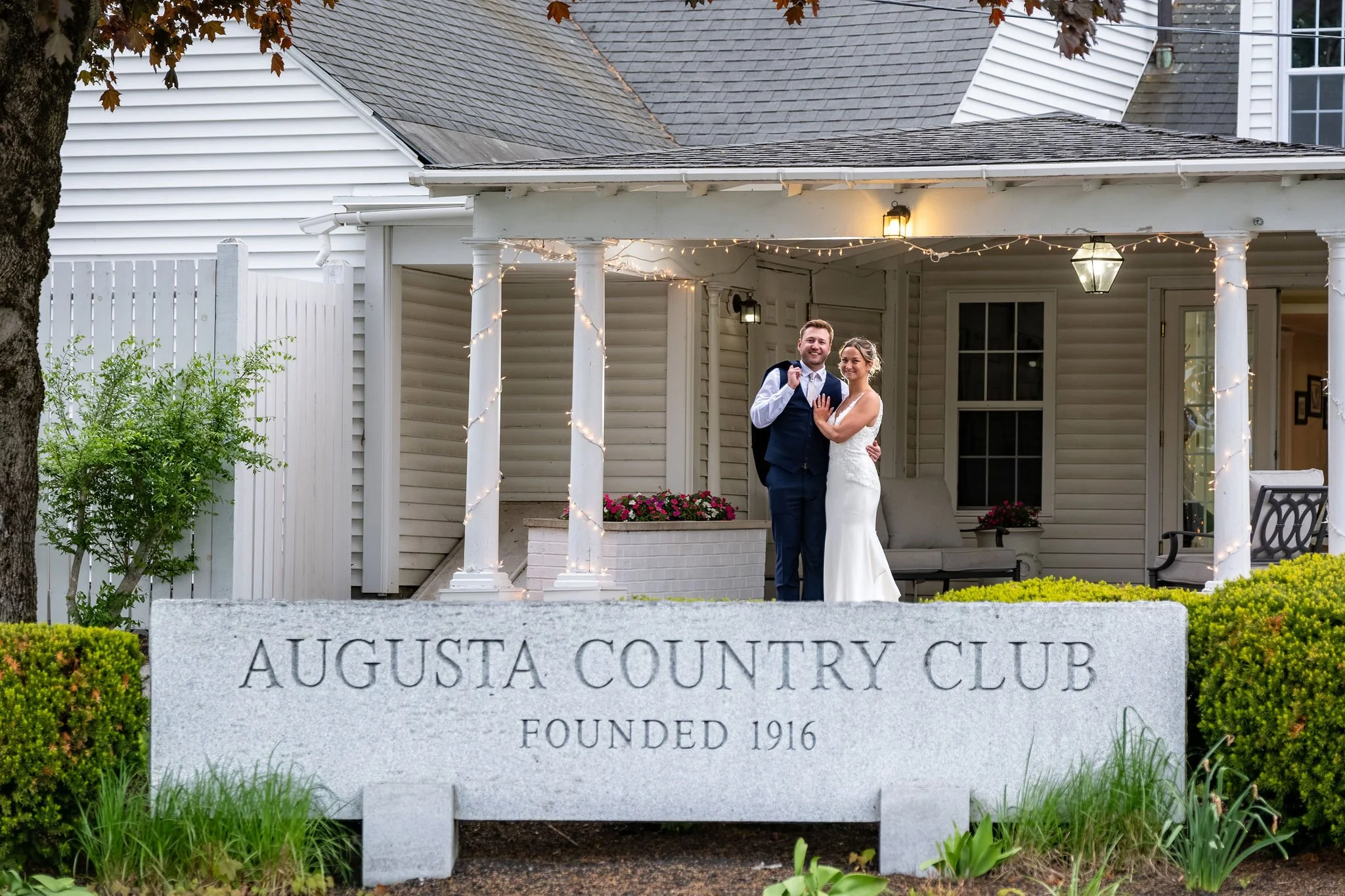 Beth and Cameron bride and groom at the Augusta Country Club sign at Augusta Country Club Manchester Maine spring wedding photography VMG Productions