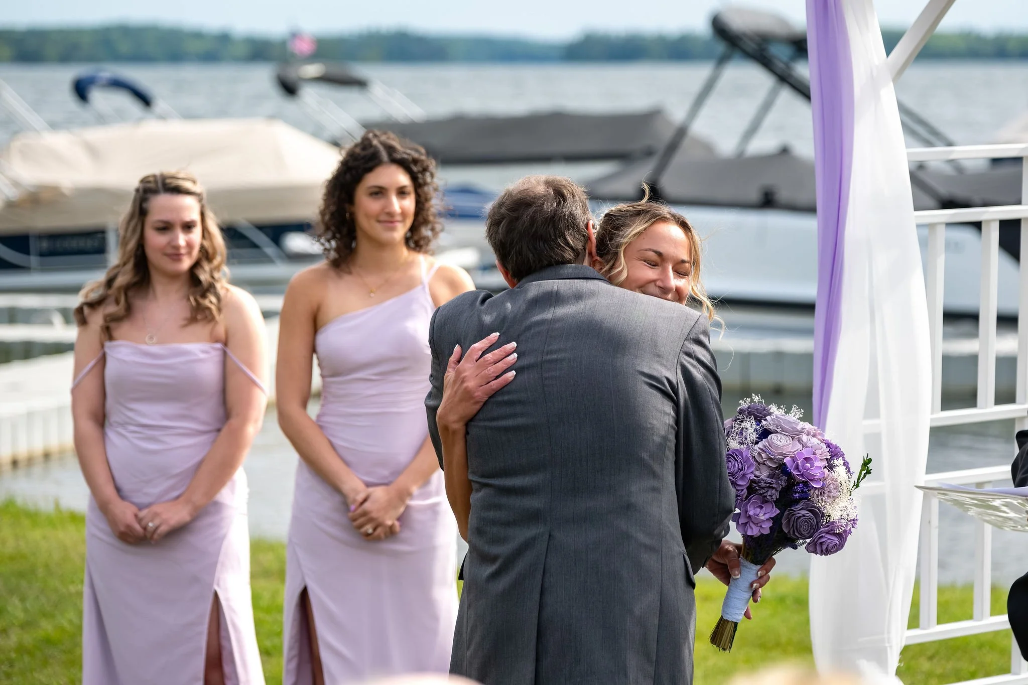 Beth and Cameron bride embracing her father at the ceremony arbor at Augusta Country Club Manchester Maine spring wedding photography VMG Productions