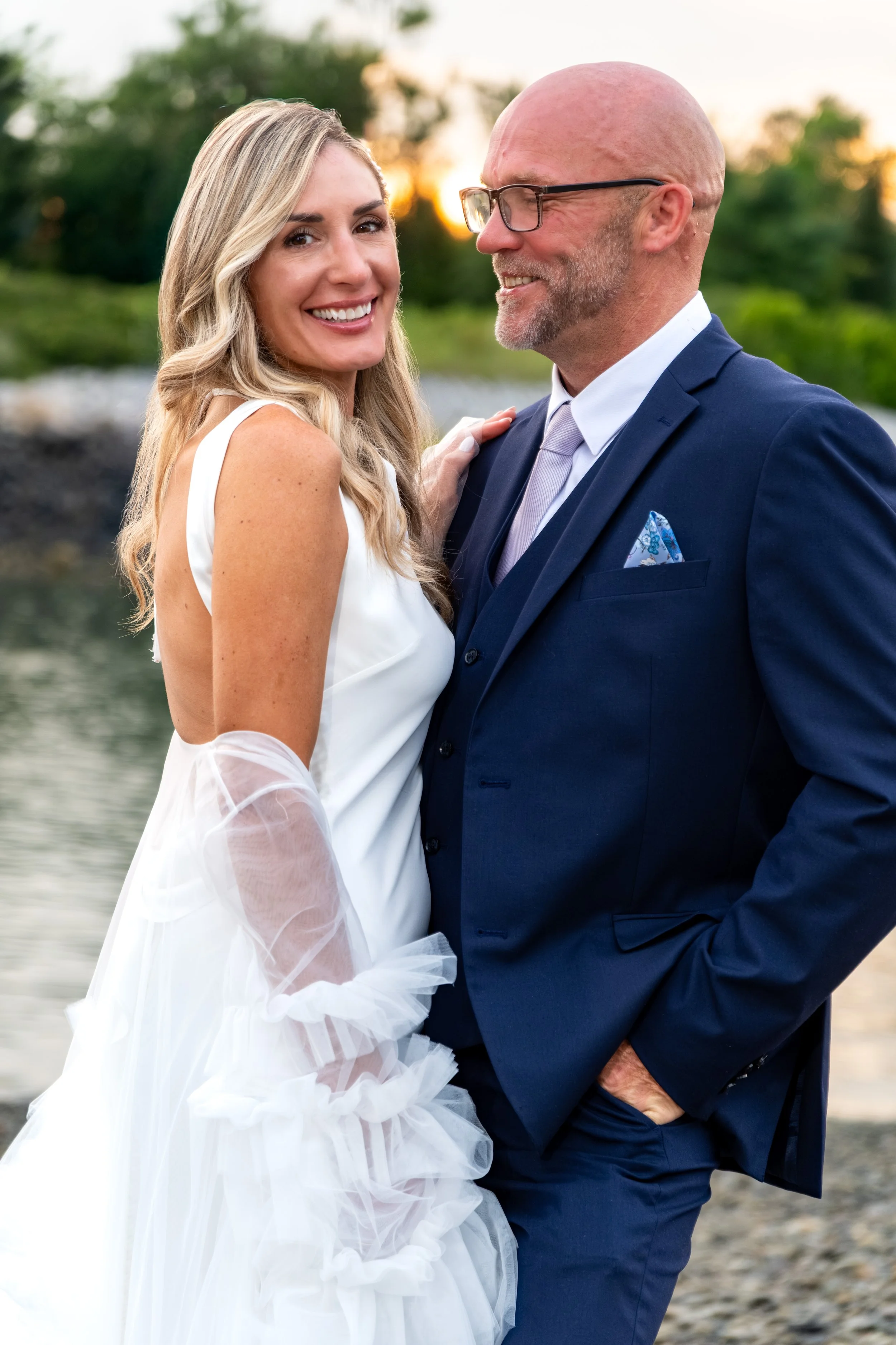 Ashley and Marc Draper close together at sunset on the shoreline at The Breakwater Inn in Kennebunkport Maine summer wedding photography VMG Productions