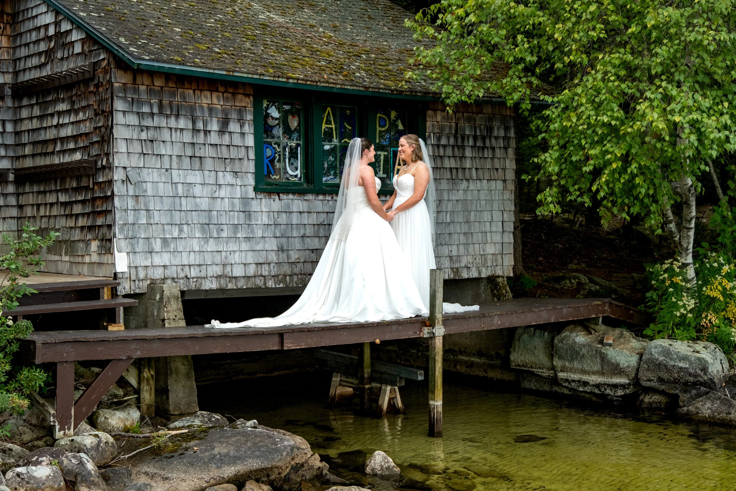 Emma and Hannah wedding portrait on dock, Maine lakeside wedding