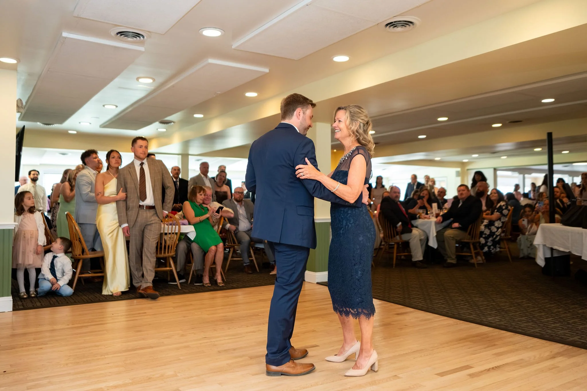 Beth and Cameron groom sharing a candid family dance at the reception at Augusta Country Club Manchester Maine spring wedding photography VMG Productions