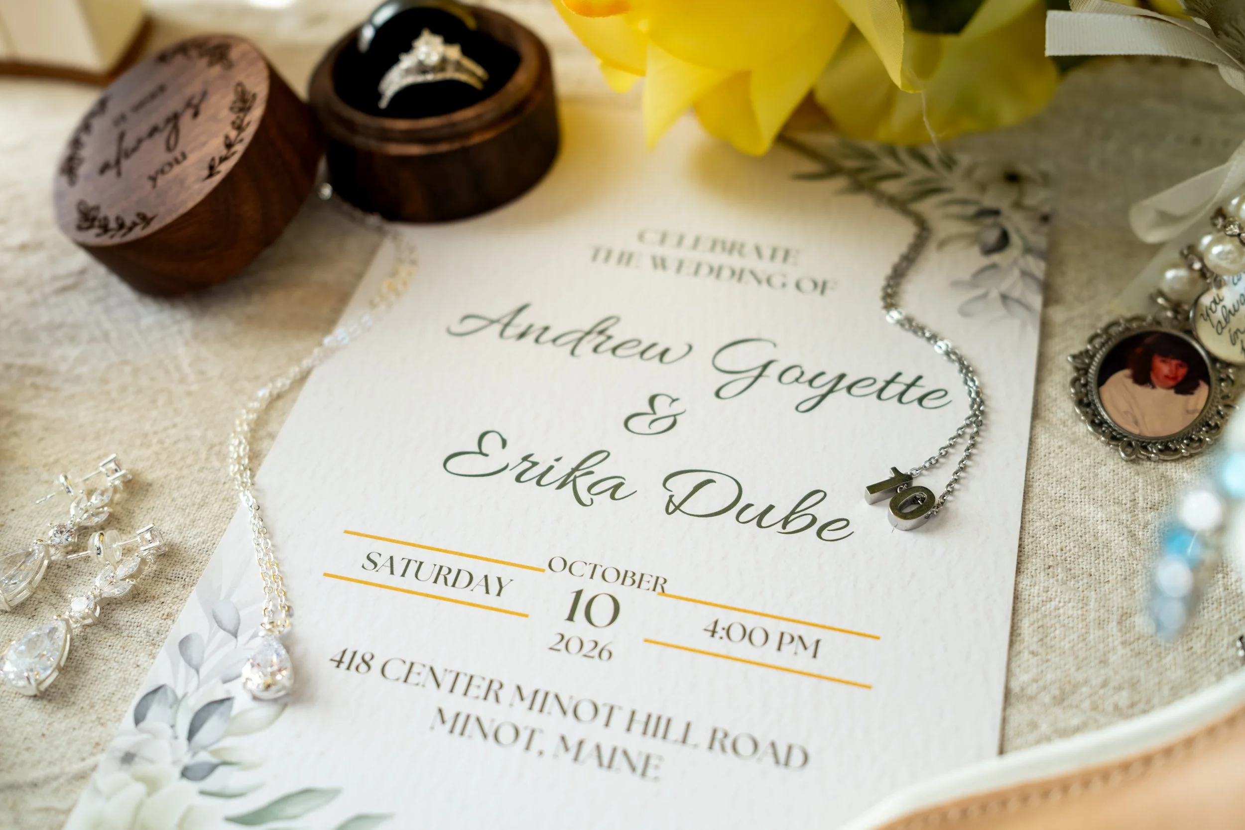 Wedding invitation with ring boxes and pearl earrings on a lace runner at the Maine Wedding Barn and Event Center in Minot Maine fall wedding photography VMG Productions