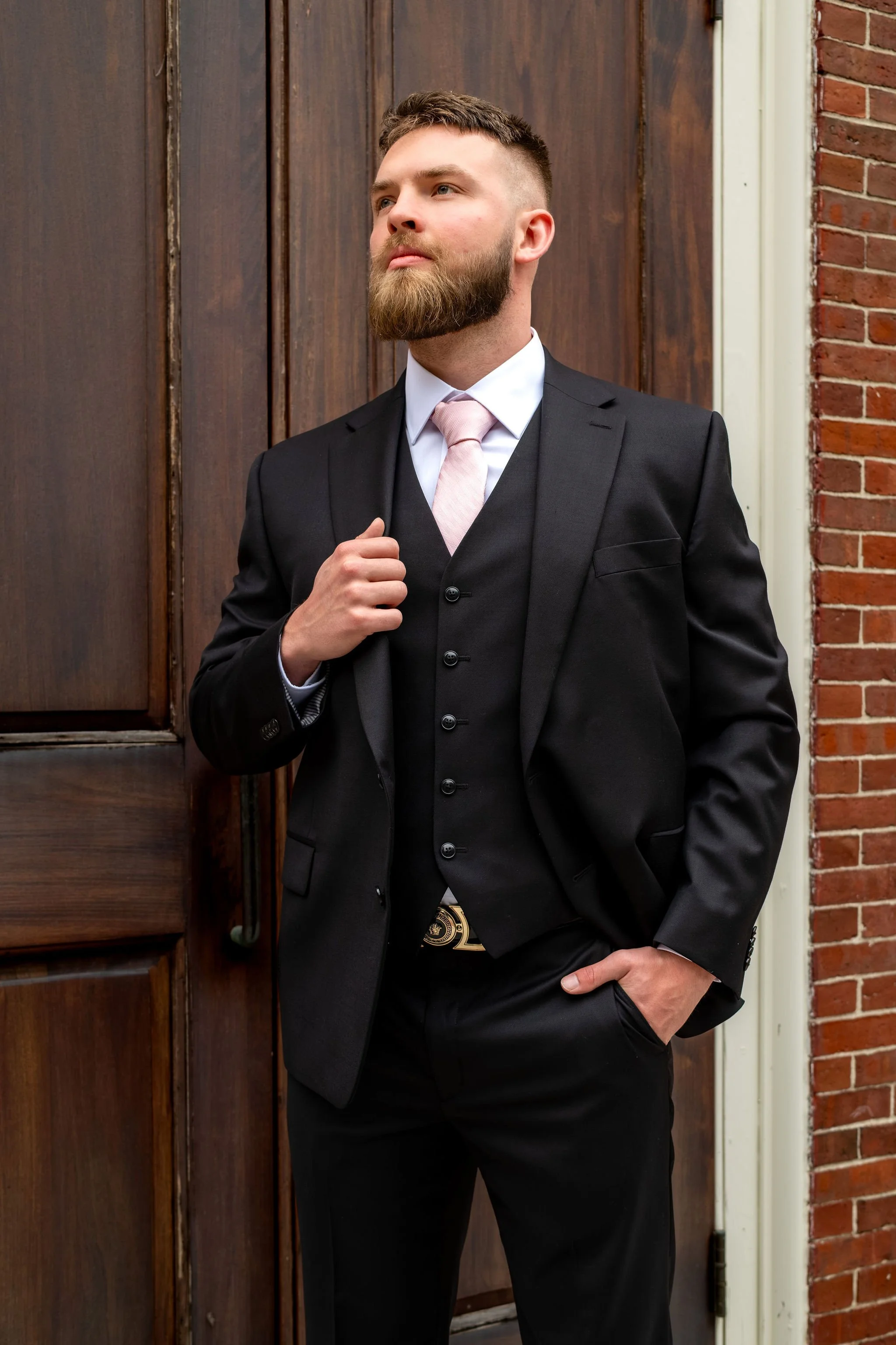 Jeremiah and Vienna refined groom portrait with hand in pocket and confident expression at Holy Trinity Greek Orthodox Church Portland Maine spring wedding photography VMG Productions
