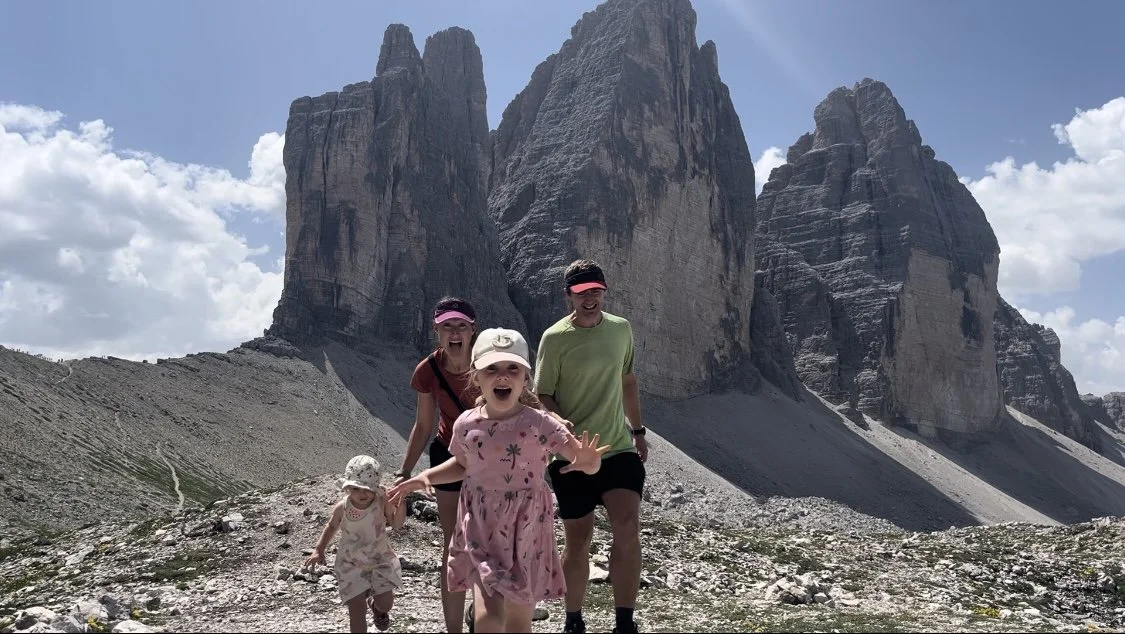 A family hiking beneath the Tre Cime peaks in the Dolomites