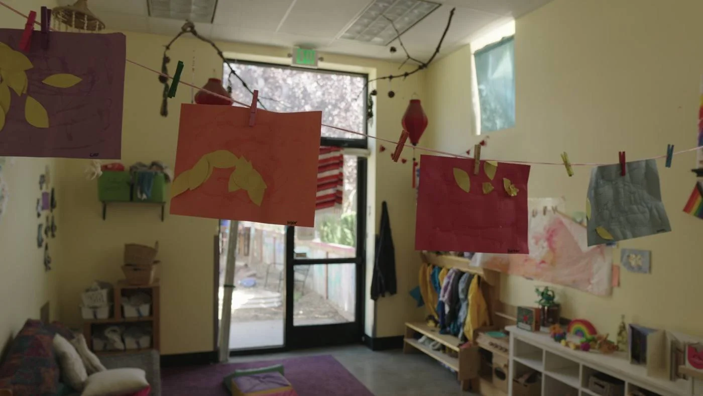 Art hanging in a classroom window at Wow and Flutterville