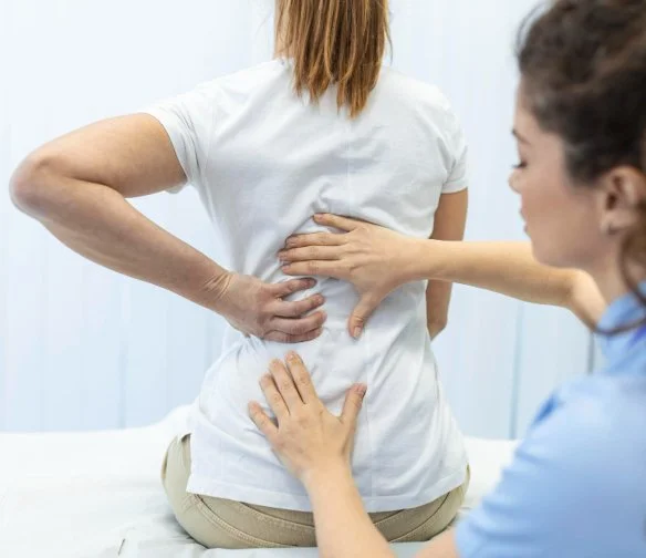 Car accident doctor in Quail Creek Oklahoma City examining lumbar spine of patient after a car crash
