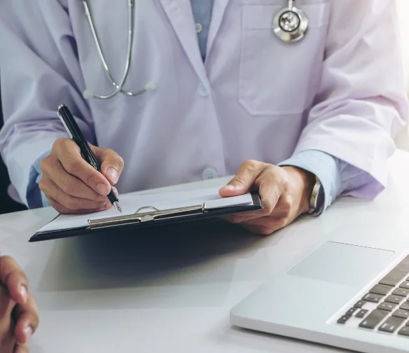 Car accident doctor in Remington OKC filling out a medical form