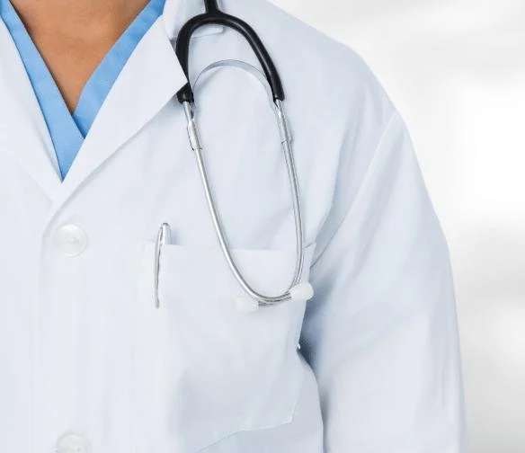Closeup of a car accident doctor in Belle Isle Oklahoma city wearing a white coat with a stethoscope