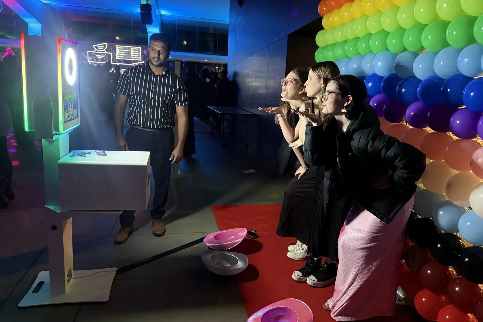 Minus18 Queer Formal guests using the Bonds sponsored photo booth in front of the Pride Balloon Wall