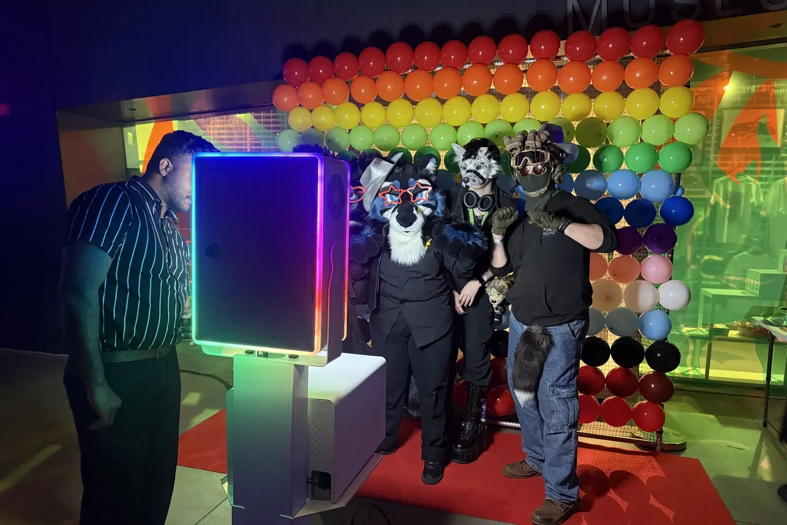 Queer Formal guests celebrating together at the Pride Balloon Wall photo booth sponsored by Bonds