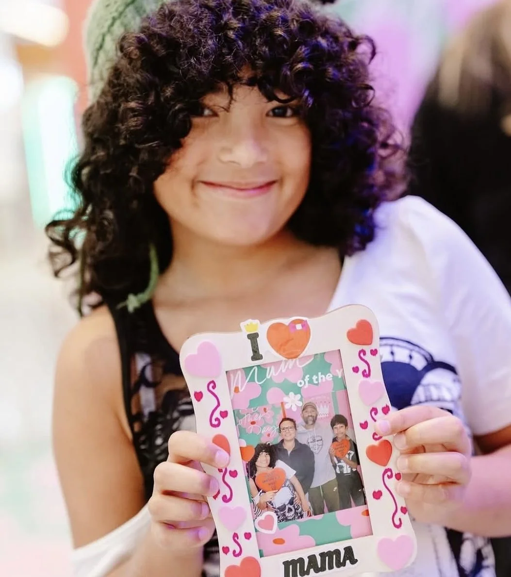Girl holding decorated Mother’s Day photo frame from Westfield Knox photo booth activation