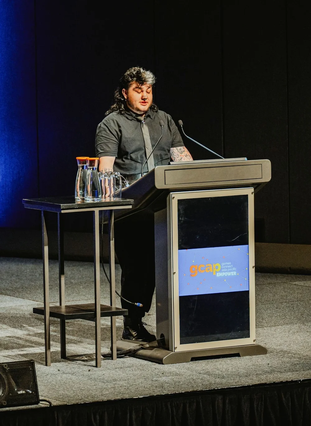 Keynote speaker photographed on stage at GCAP Conference Melbourne