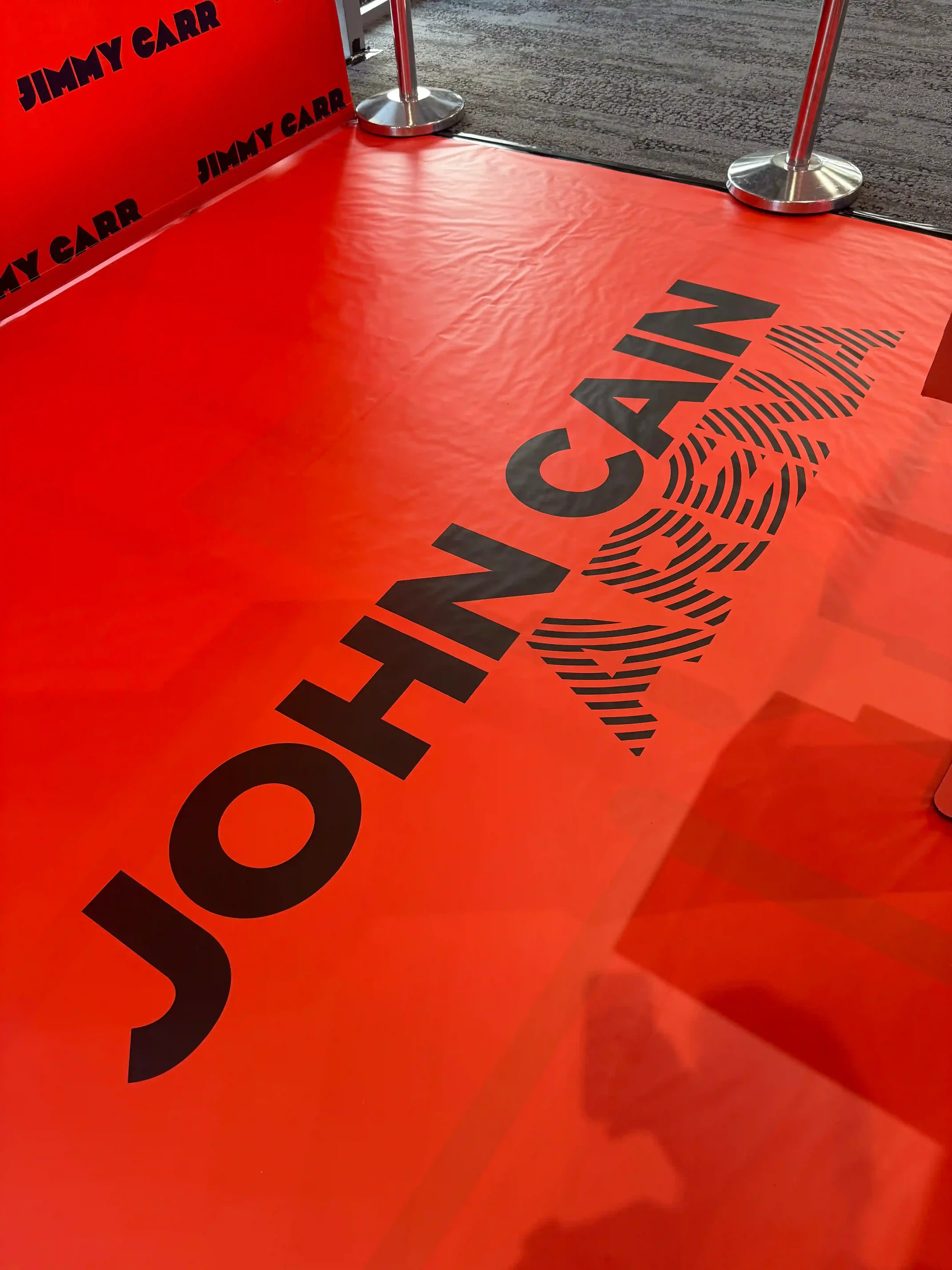 John Cain Arena branded floor wrap for Jimmy Carr photo booth activation