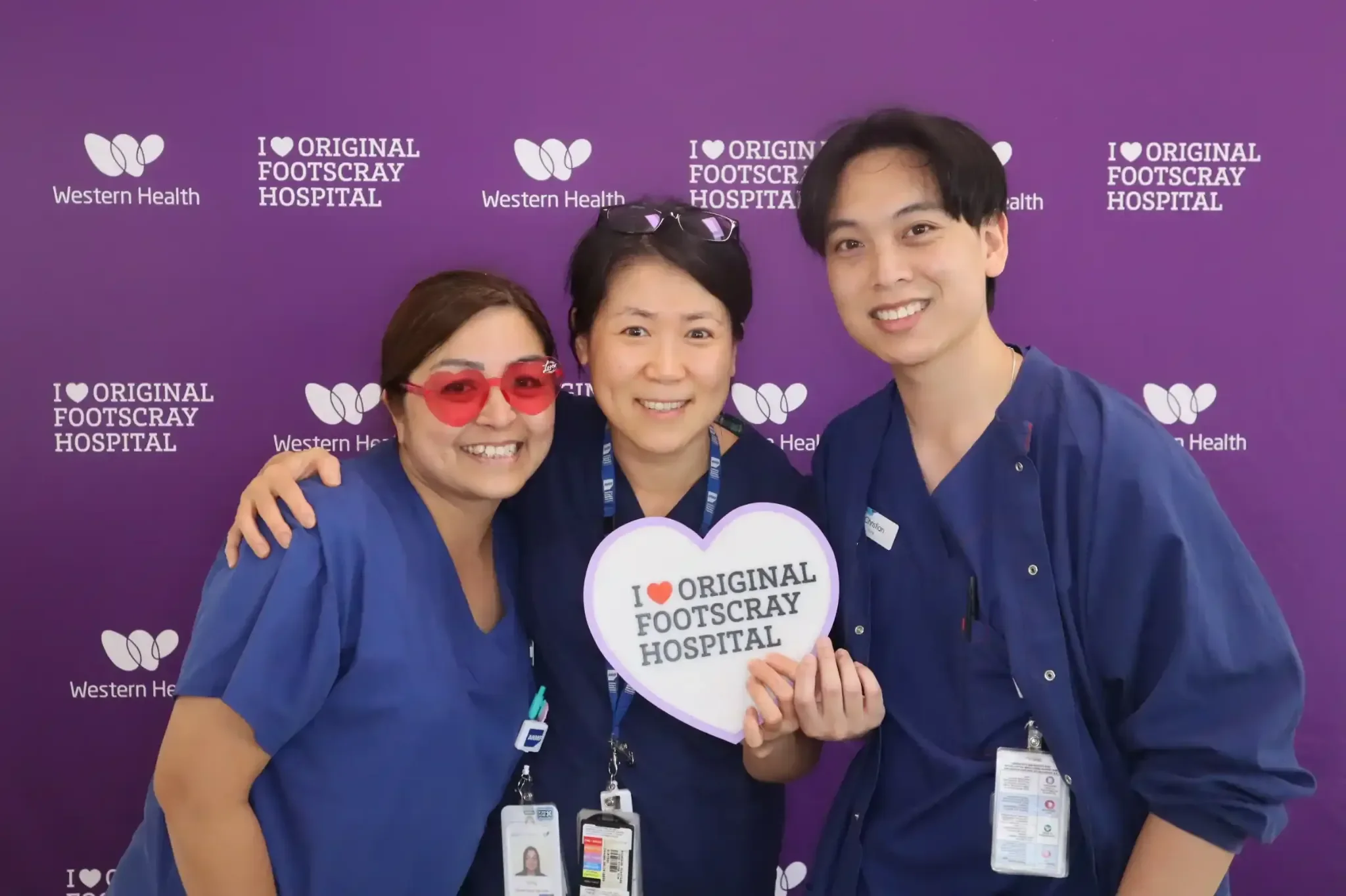 Premium corporate photo booth hire Melbourne healthcare staff with branded Western Health backdrop