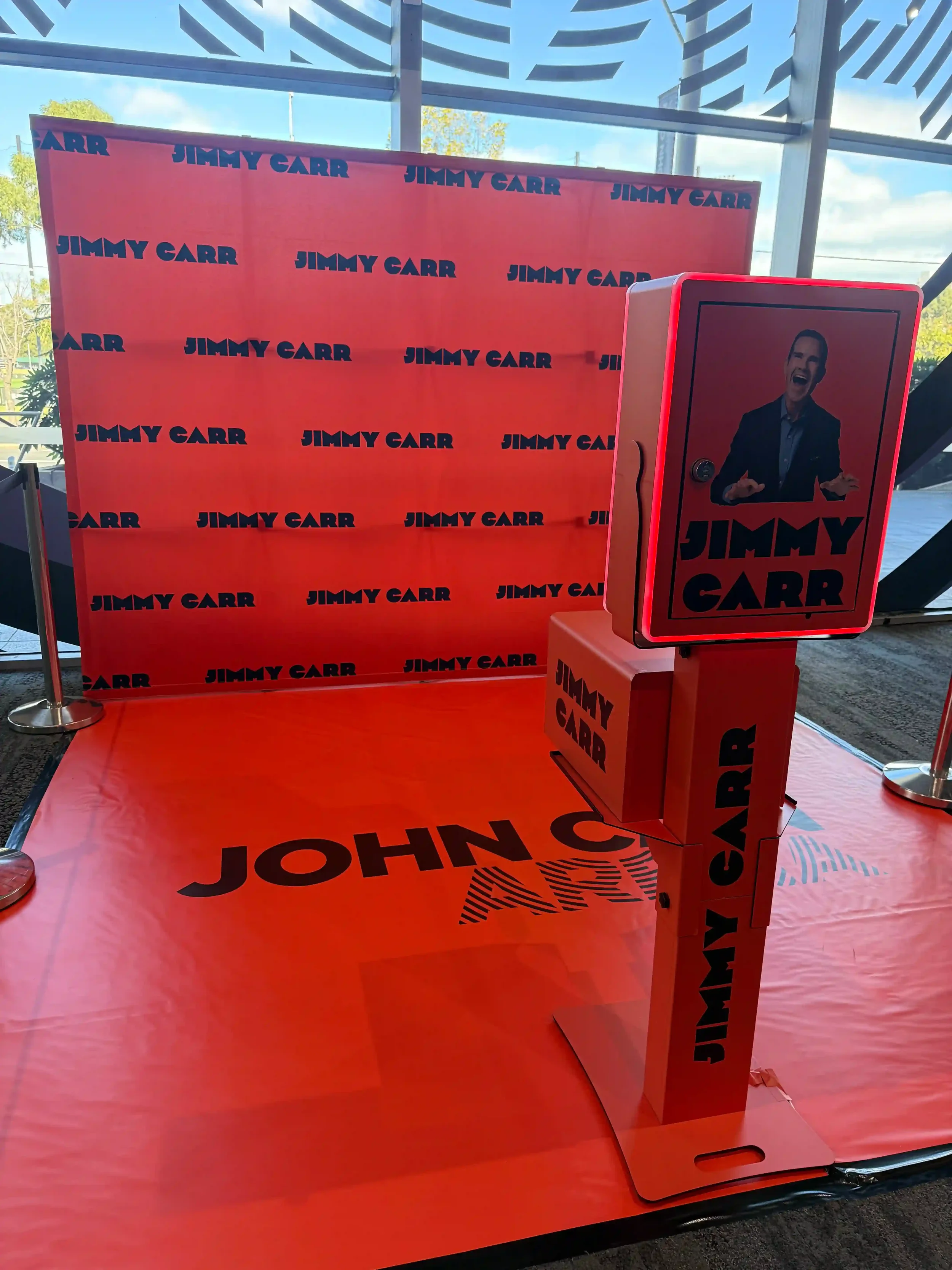 Jimmy Carr photo booth activation setup with branded wall and booth wrap