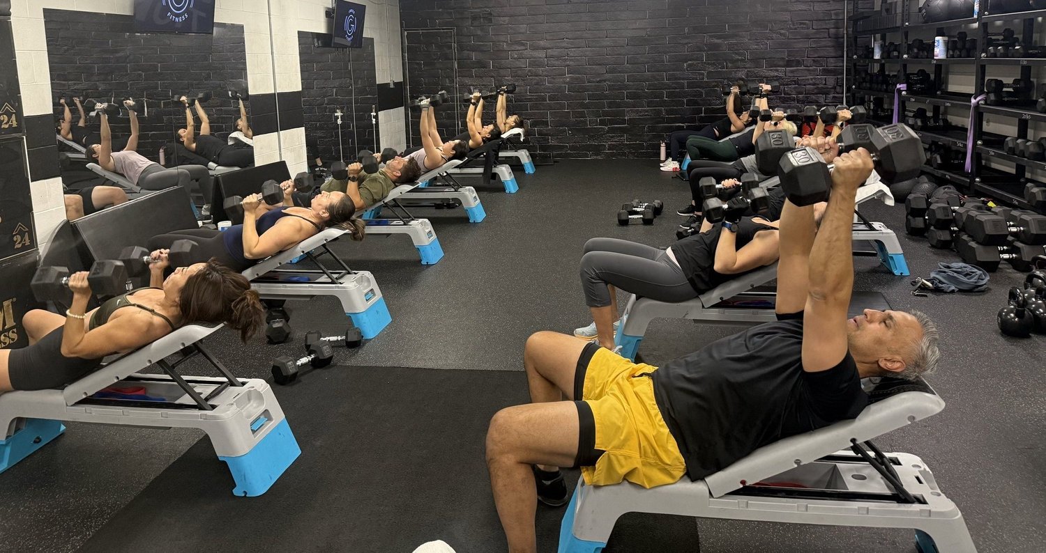 Small group class doing dumbbell presses at Inner G Fitness in Vaughan