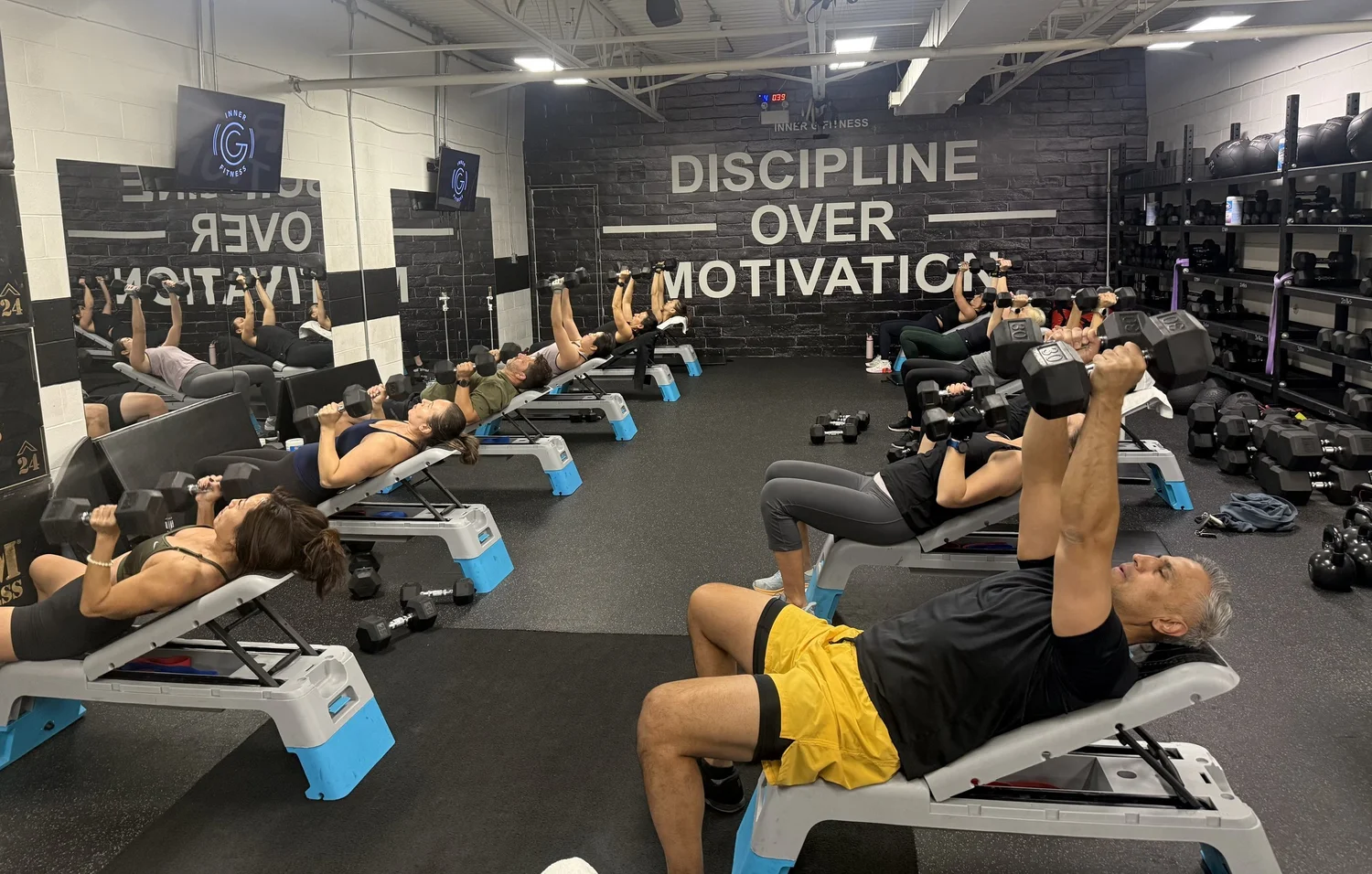 Small group class doing dumbbell presses at Inner G Fitness in Vaughan
