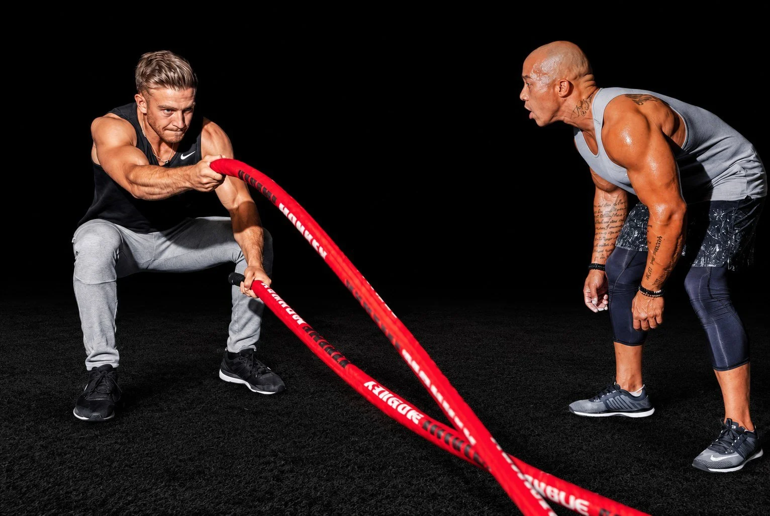 A coach cueing a client through battle ropes at Inner G Fitness