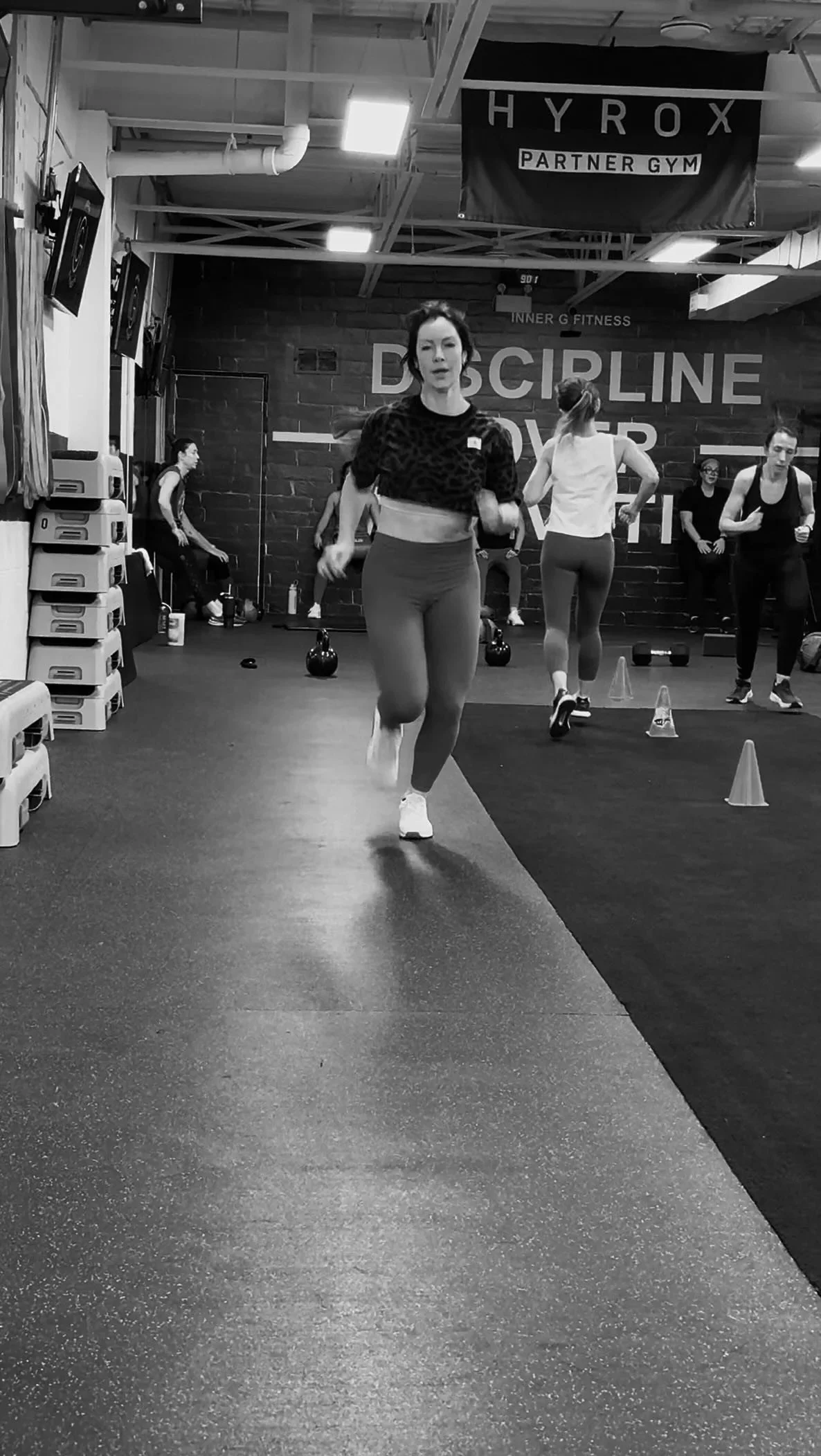 Members running conditioning drills in a small-group class at Inner G Fitness