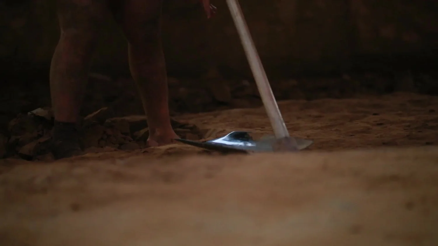 A spade turns the earth of the akhada pit