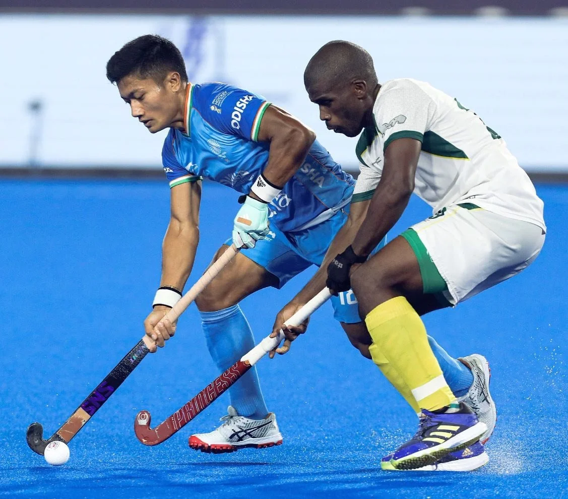 Nilakanta Sharma shields the ball from a South Africa player