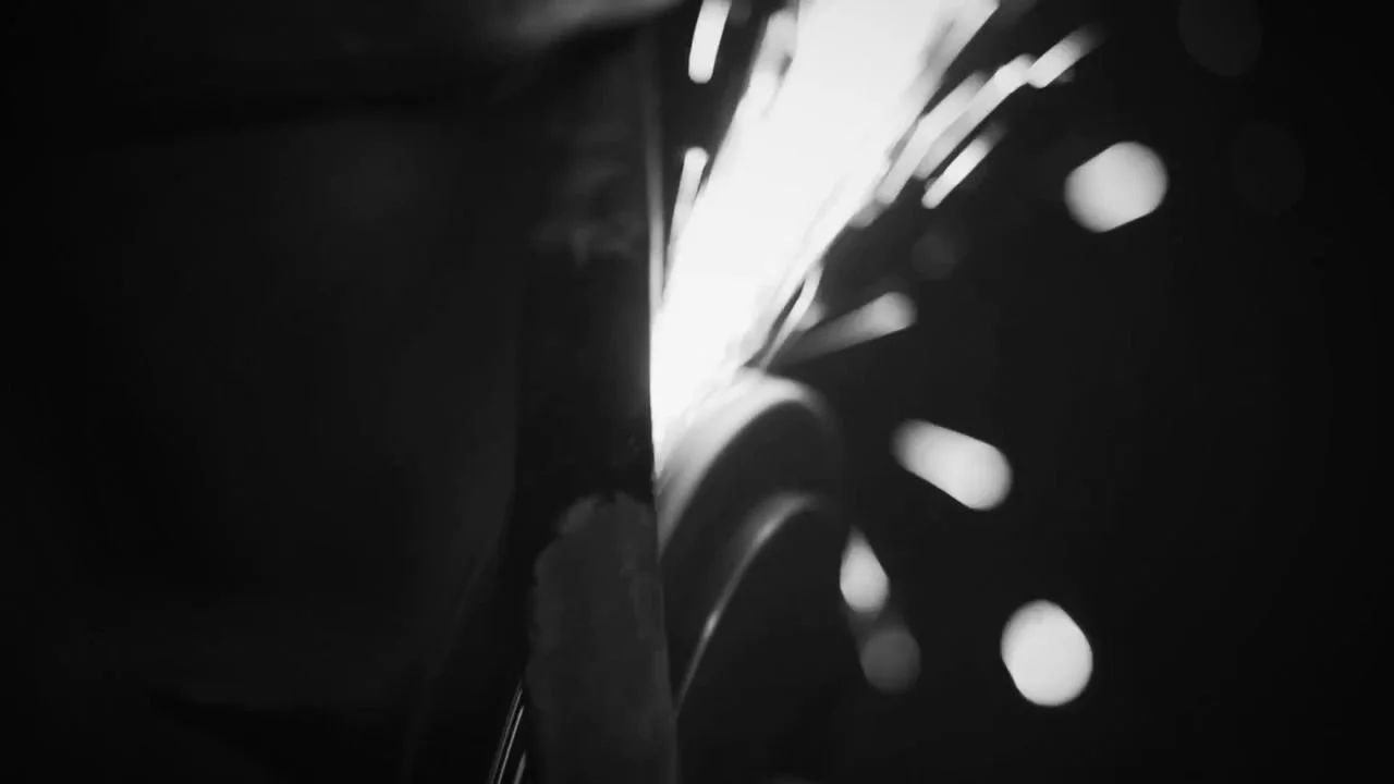 Frame 6 of 14: The wheel throwing a fan of sparks