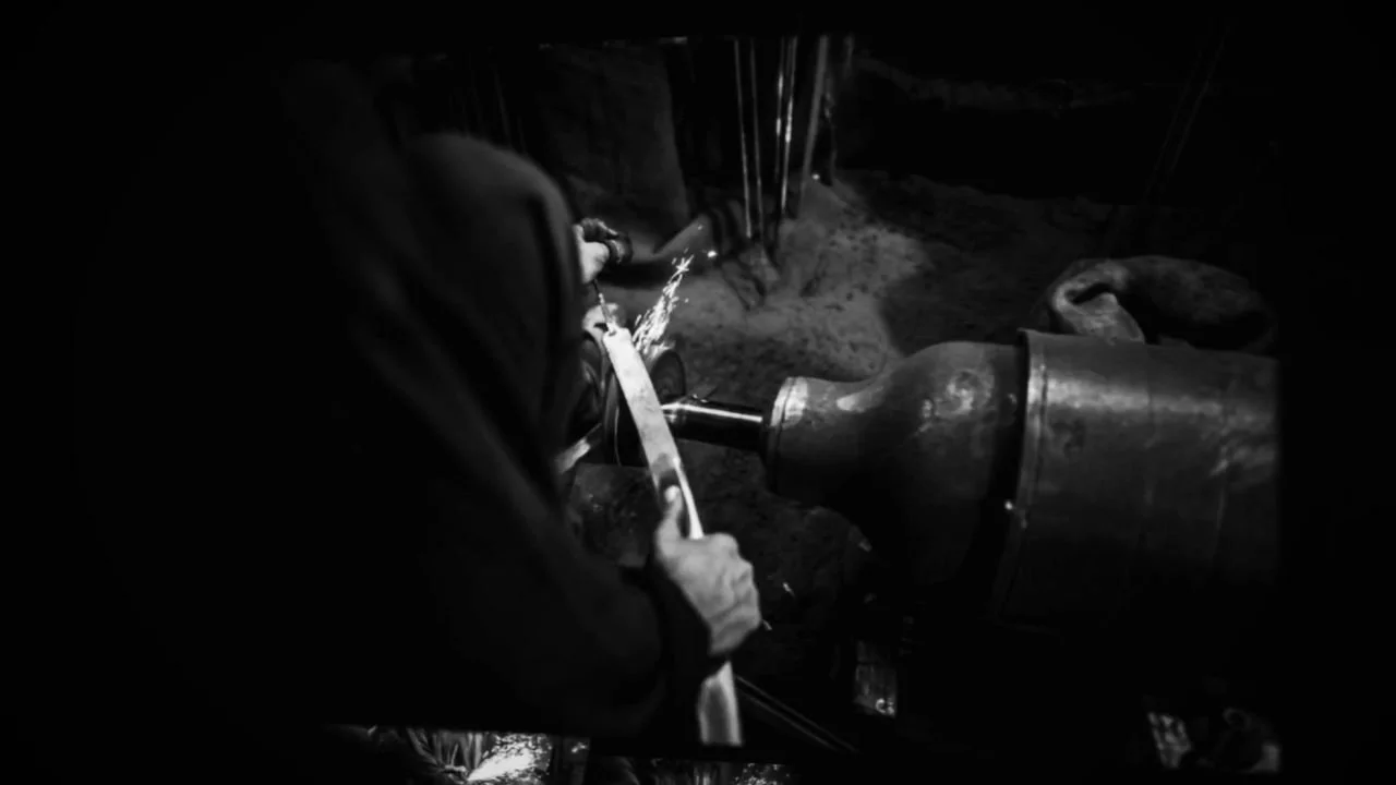 Frame 12 of 14: A karigar at the grinder