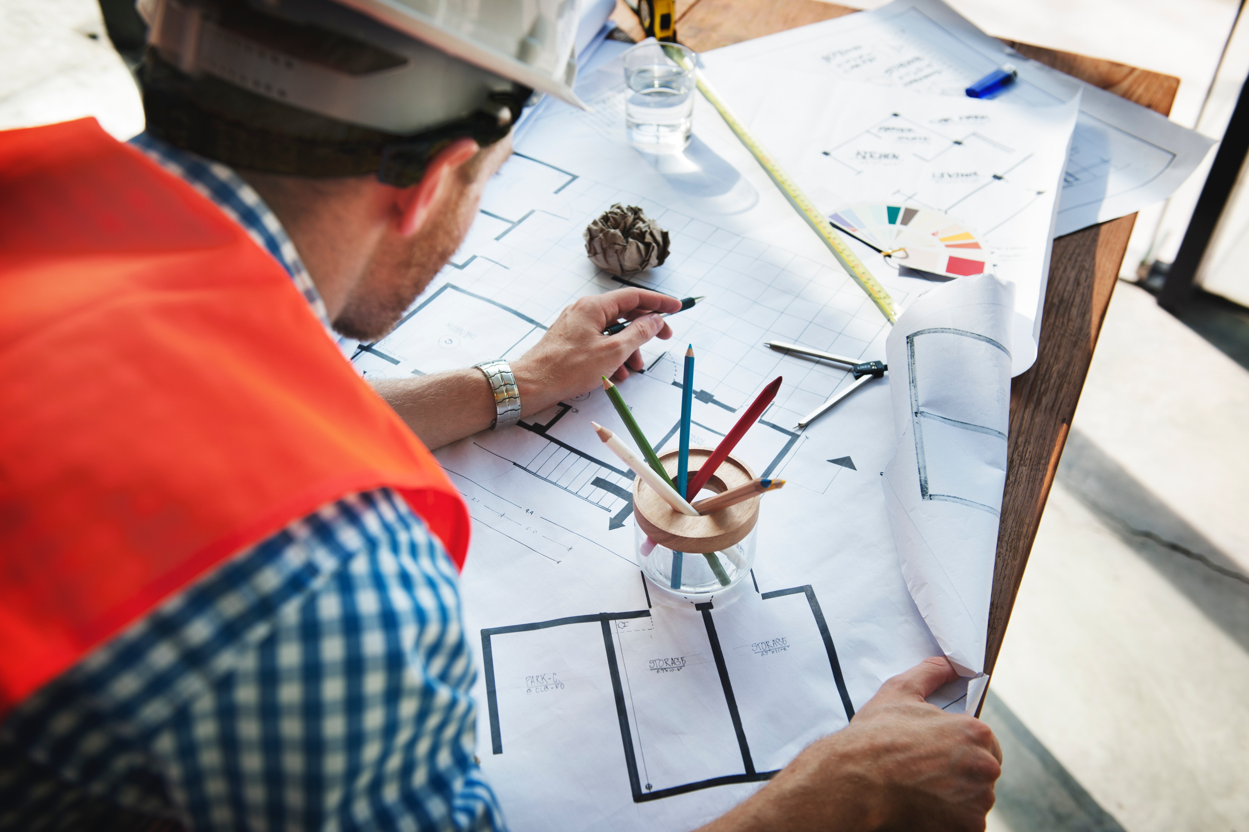 architect-reviewing-blueprints-desk-professional-architectural-design