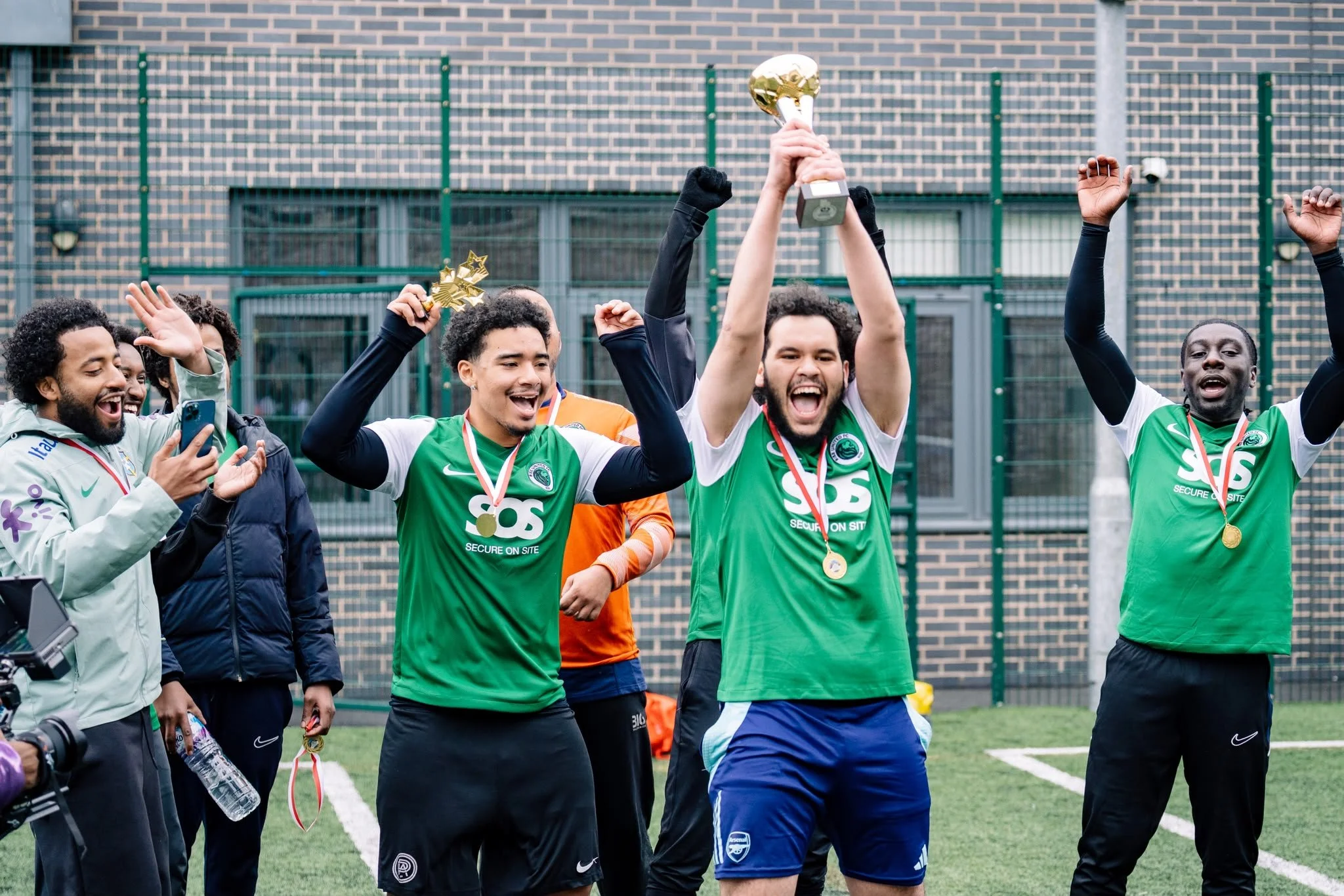 RISE players celebrating with the Haringey Community Football Tournament trophy