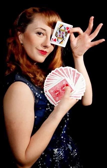Magical Katrina holding playing cards