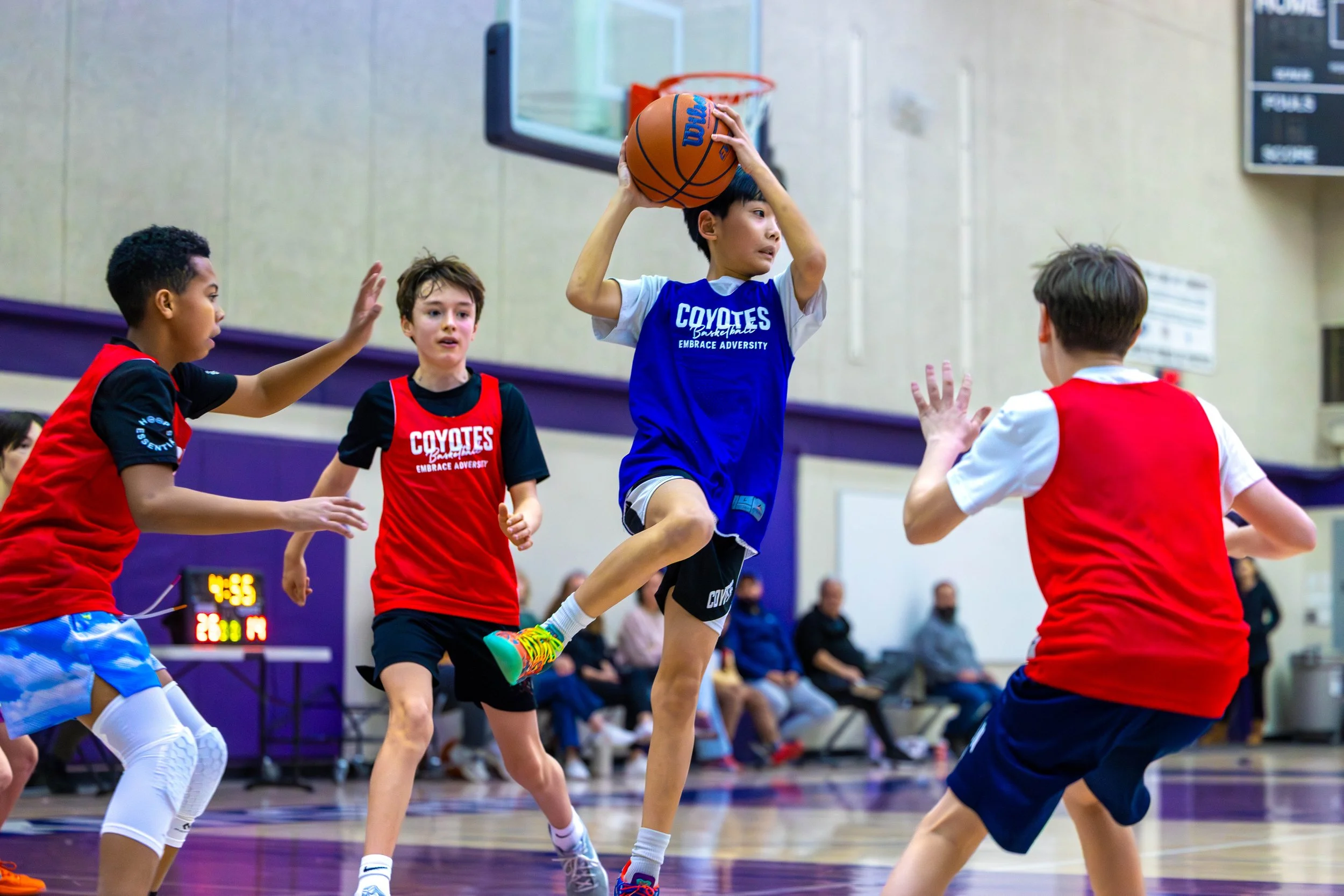 Kids playing basketball at a Junior Coyotes summer camp in Kelowna