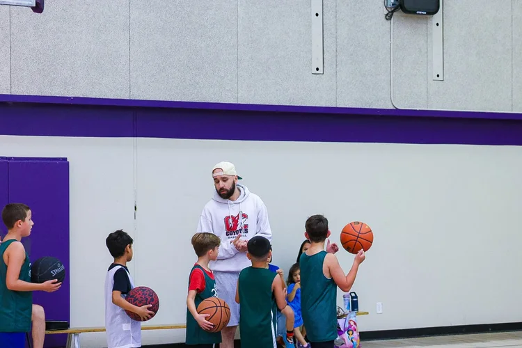 Coach Dario Gini running a Junior Coyotes session with young players