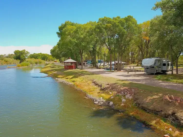Approved River Front RV sites beside the Rio Grande, with a riverside gazebo and tree-shaded campsites at Woods and River RV Park.