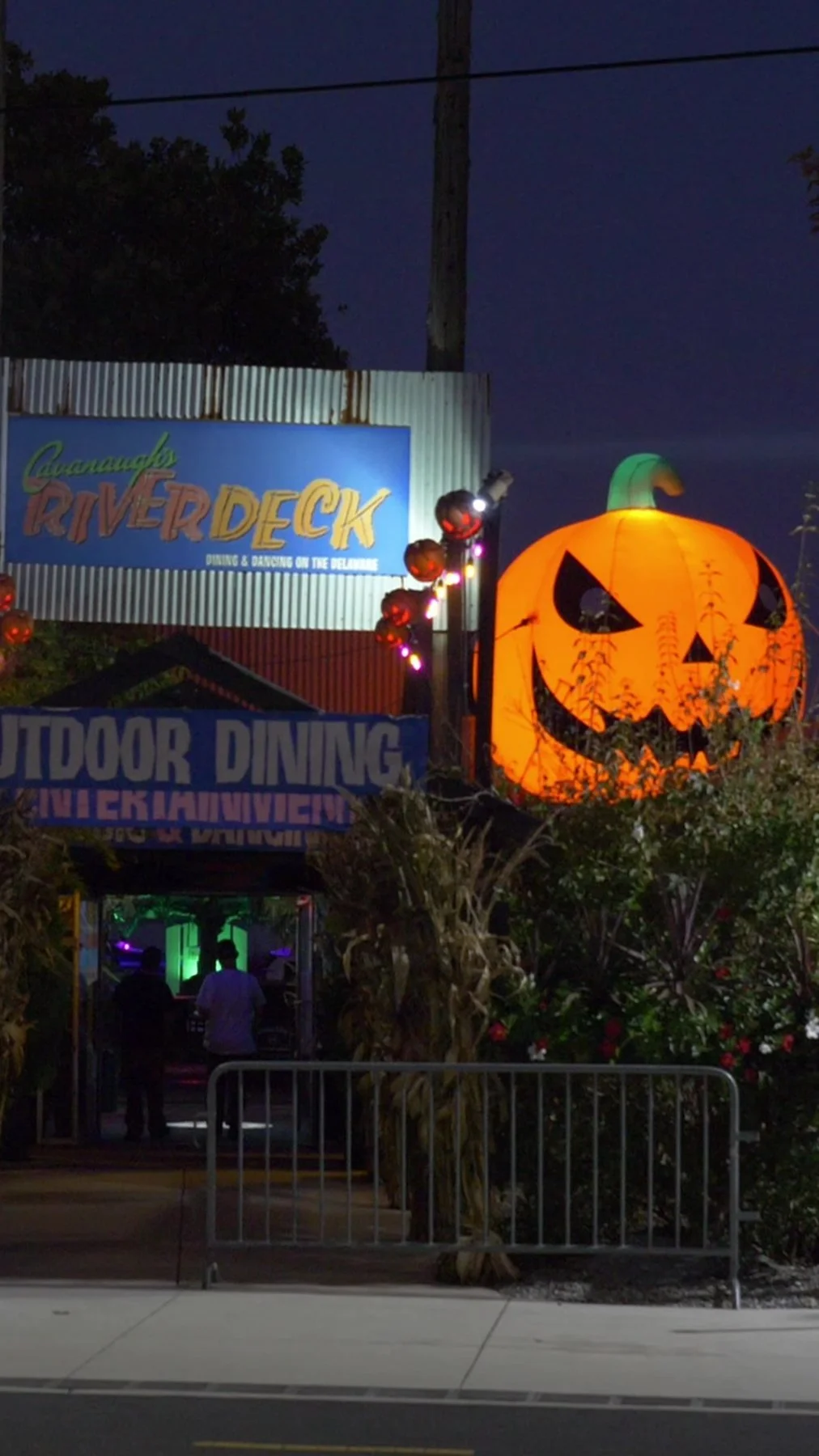 Haunted Pier entrance at Cavanaugh's River Deck with a giant glowing jack-o'-lantern