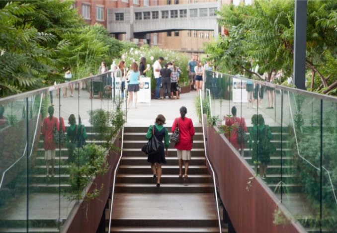 People navigate a staircase in a lively city setting, showcasing the dynamic atmosphere of urban life.