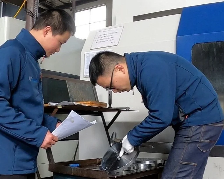 Donlouco engineer checking a machined part at the CNC facility in China