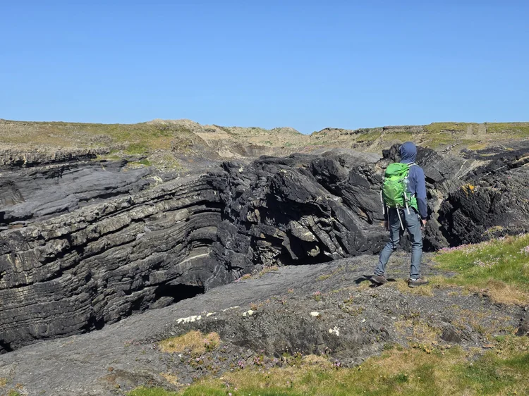 Student on folded ledges at gully