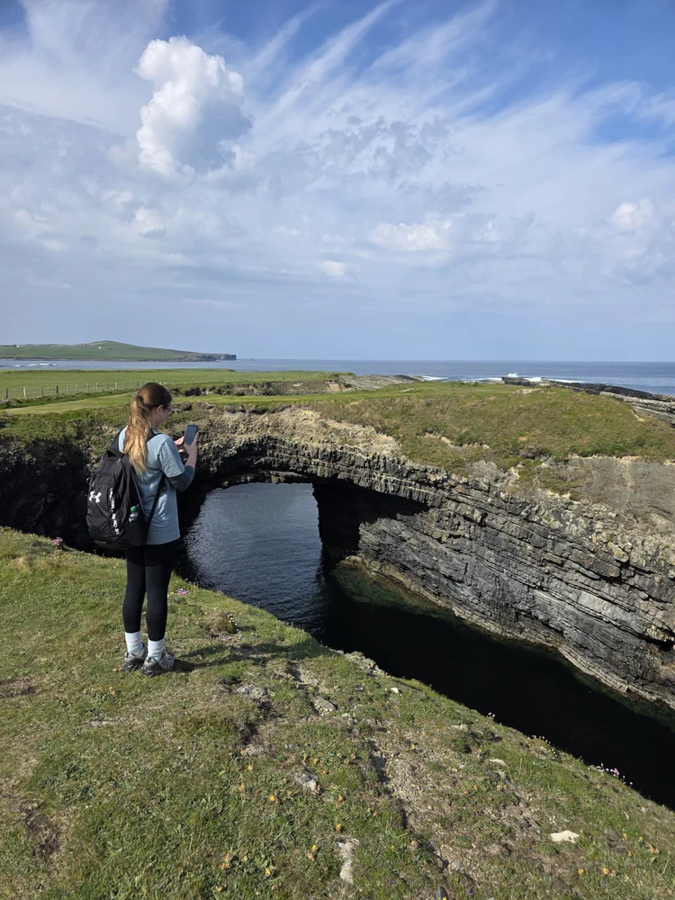 Natural arch and blowhole with students