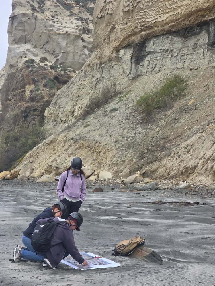 Student sketching at outcrop base