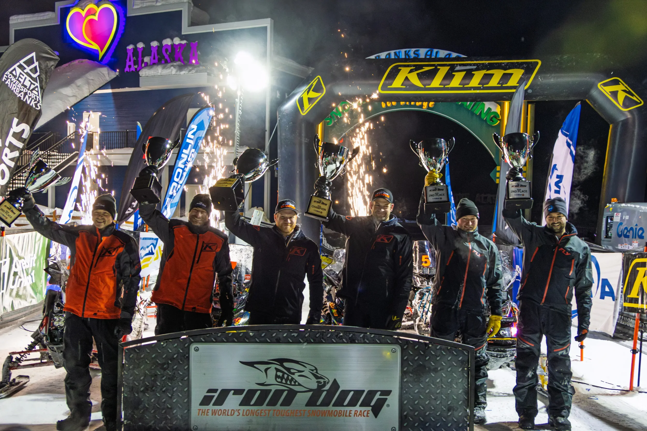 2026 Iron Dog Champions Nick Olstad and Tyler Aklestad celebrating at the finish line