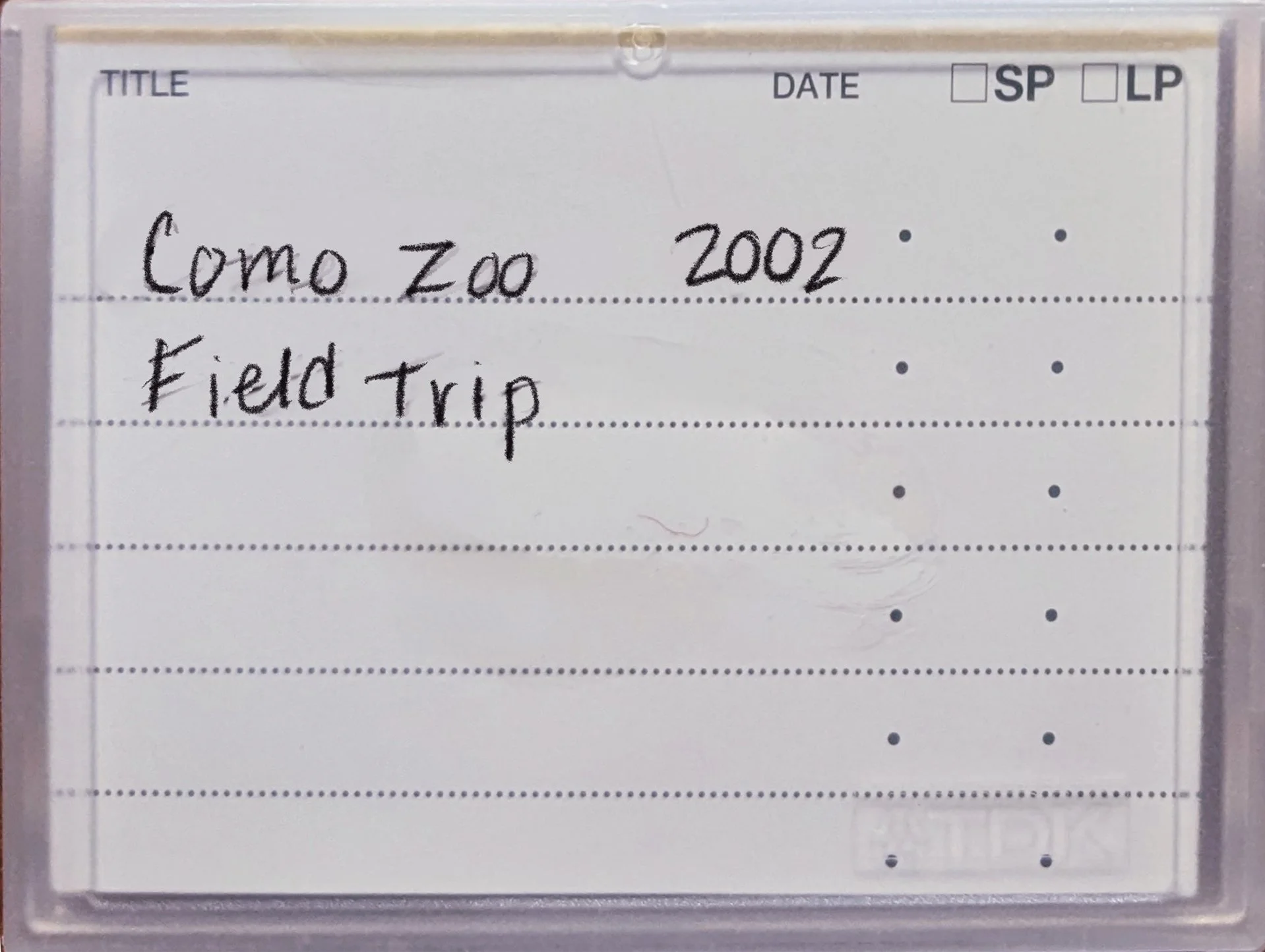 Mini DV tape case labeled Como Zoo 2002 Field Trip