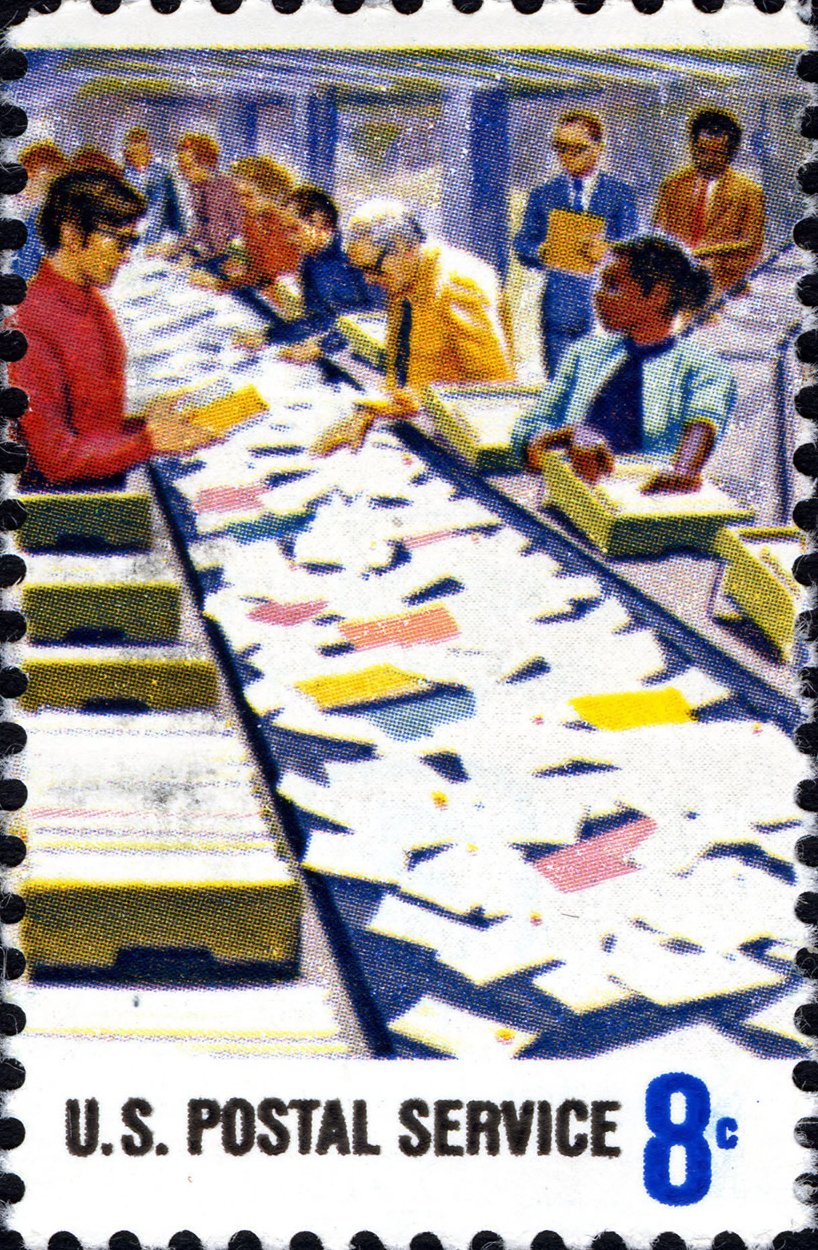 A vintage postage stamp showing a mail sorting room