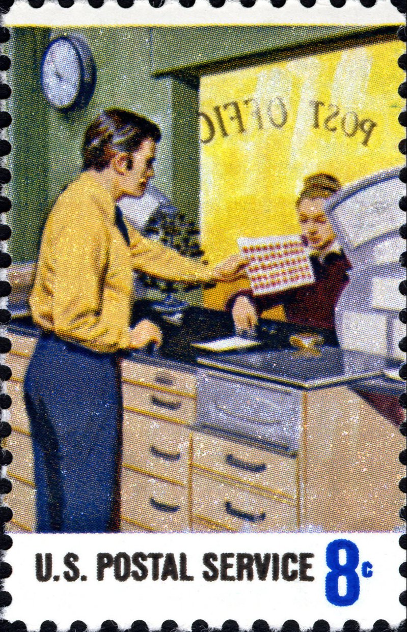 A vintage postage stamp showing someone dropping off a letter at the post office