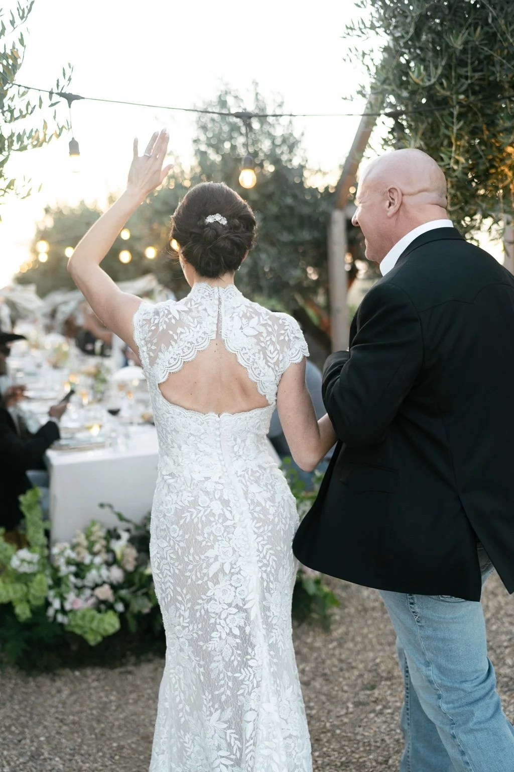 Joanna and Greg arriving at the outdoor dinner table.