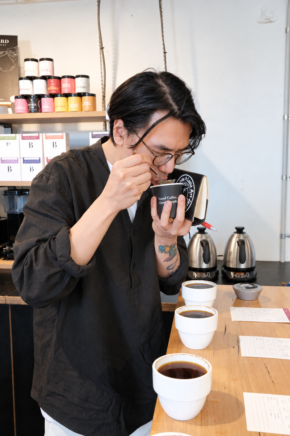 Sing tasting the coffees.