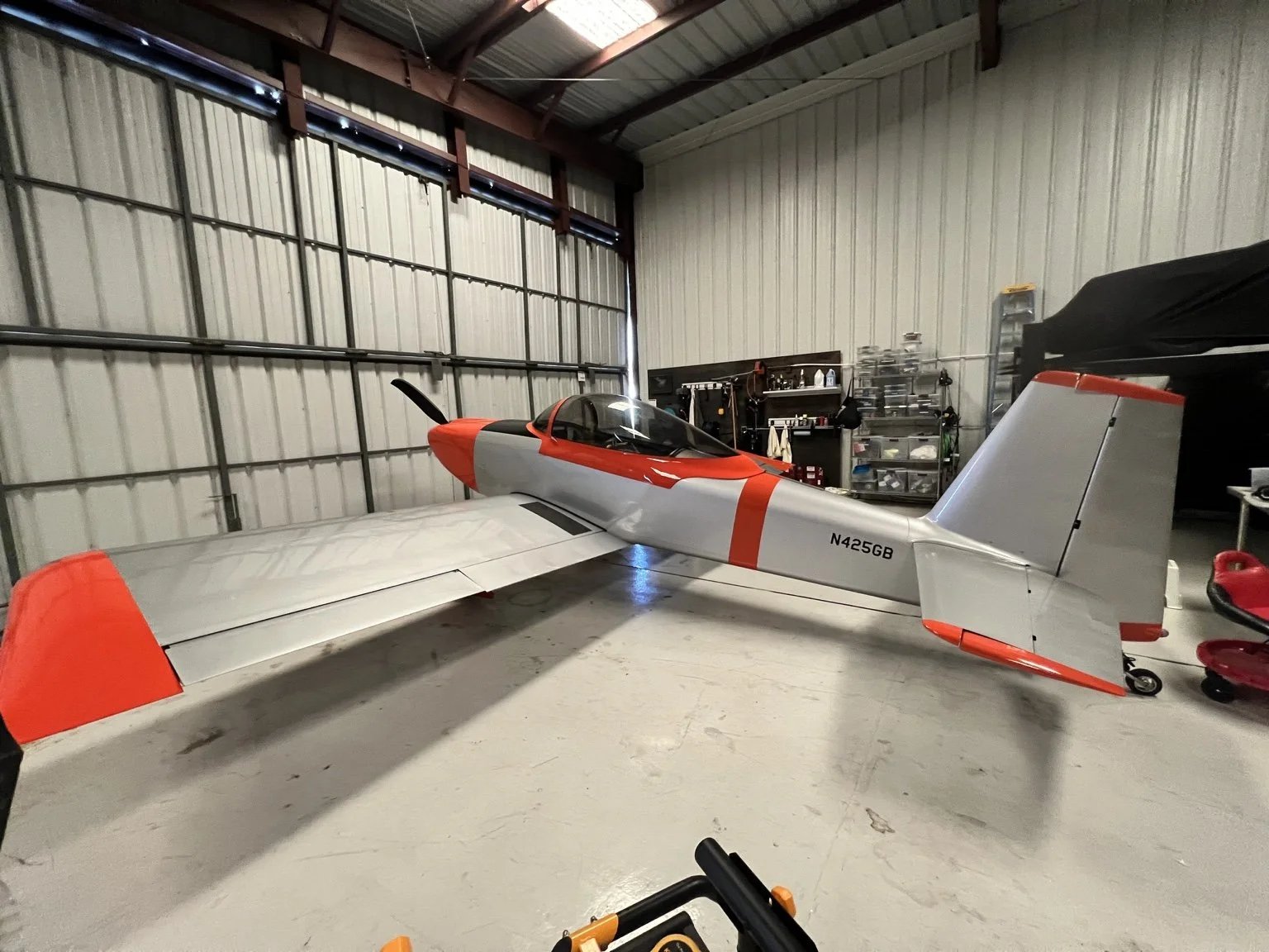 Red-and-silver RV aircraft in the hangar