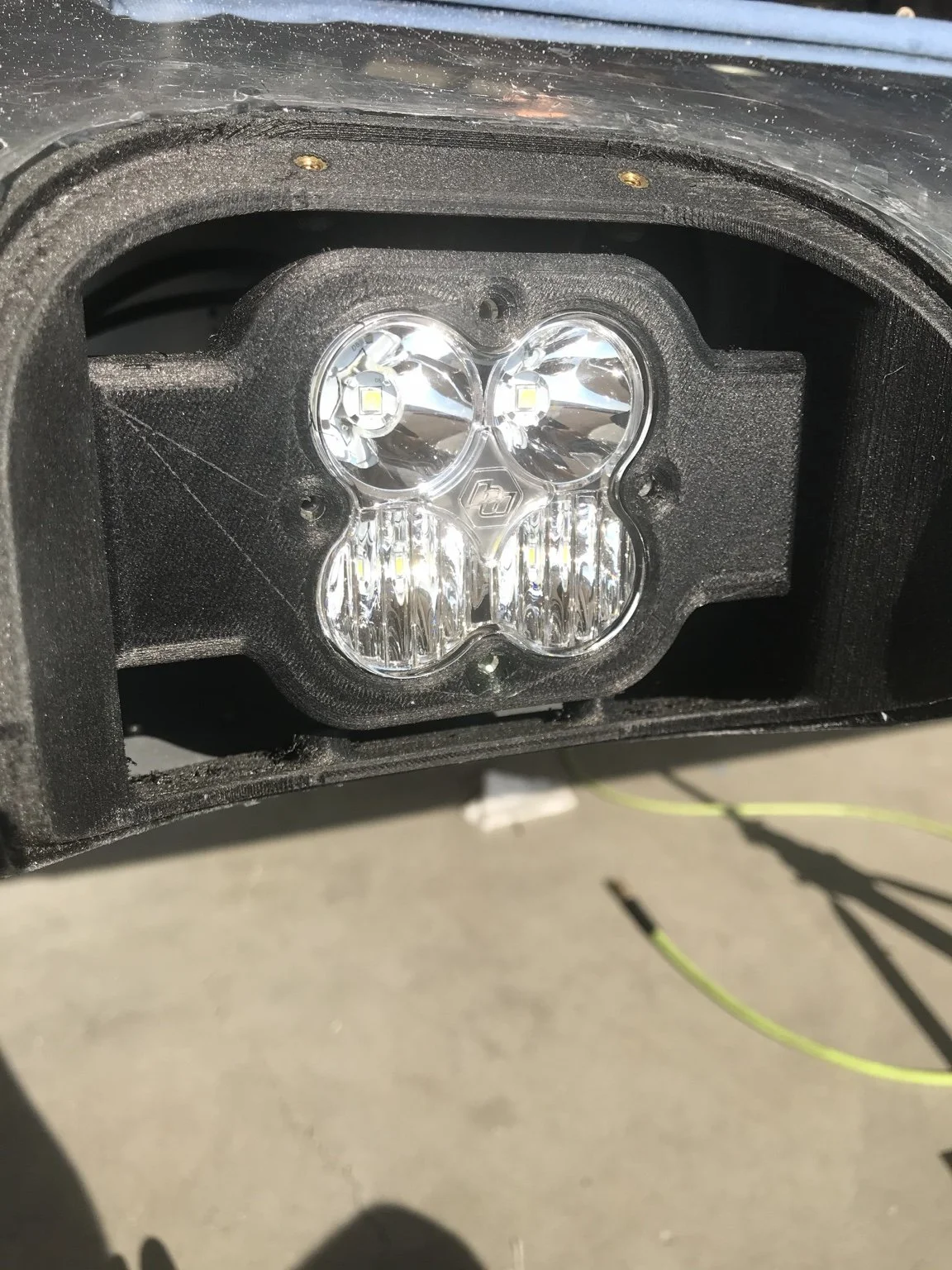Close-up of the BSR RV-10/14 LED landing light and mounting bracket installed in the leading-edge opening