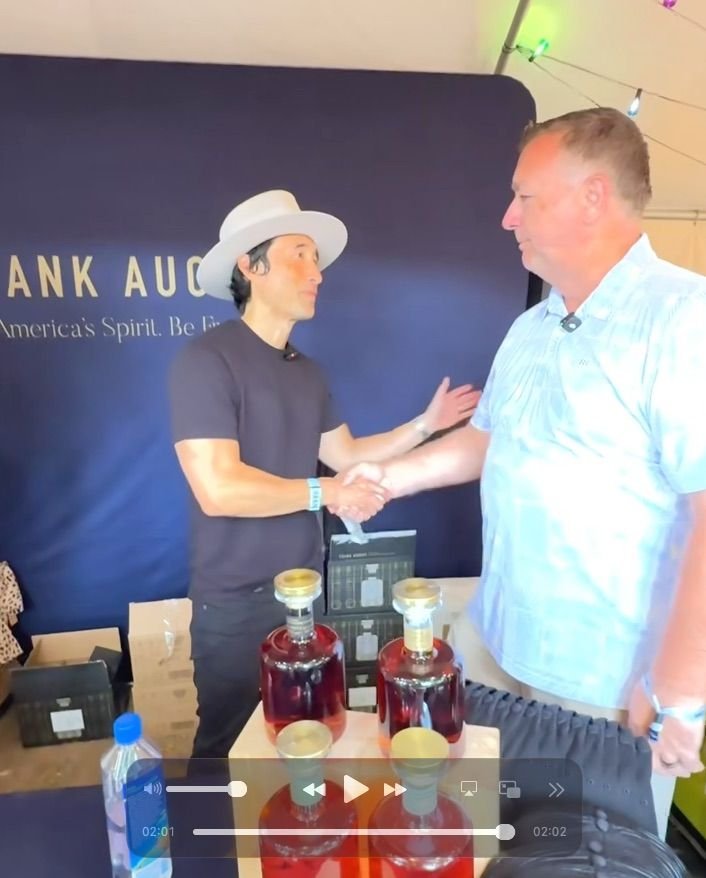 Andy Upchurch of Bin 110 shaking hands with Jonathan Crocker, CEO of Frank August, at Kentucky Bourbon Festival.