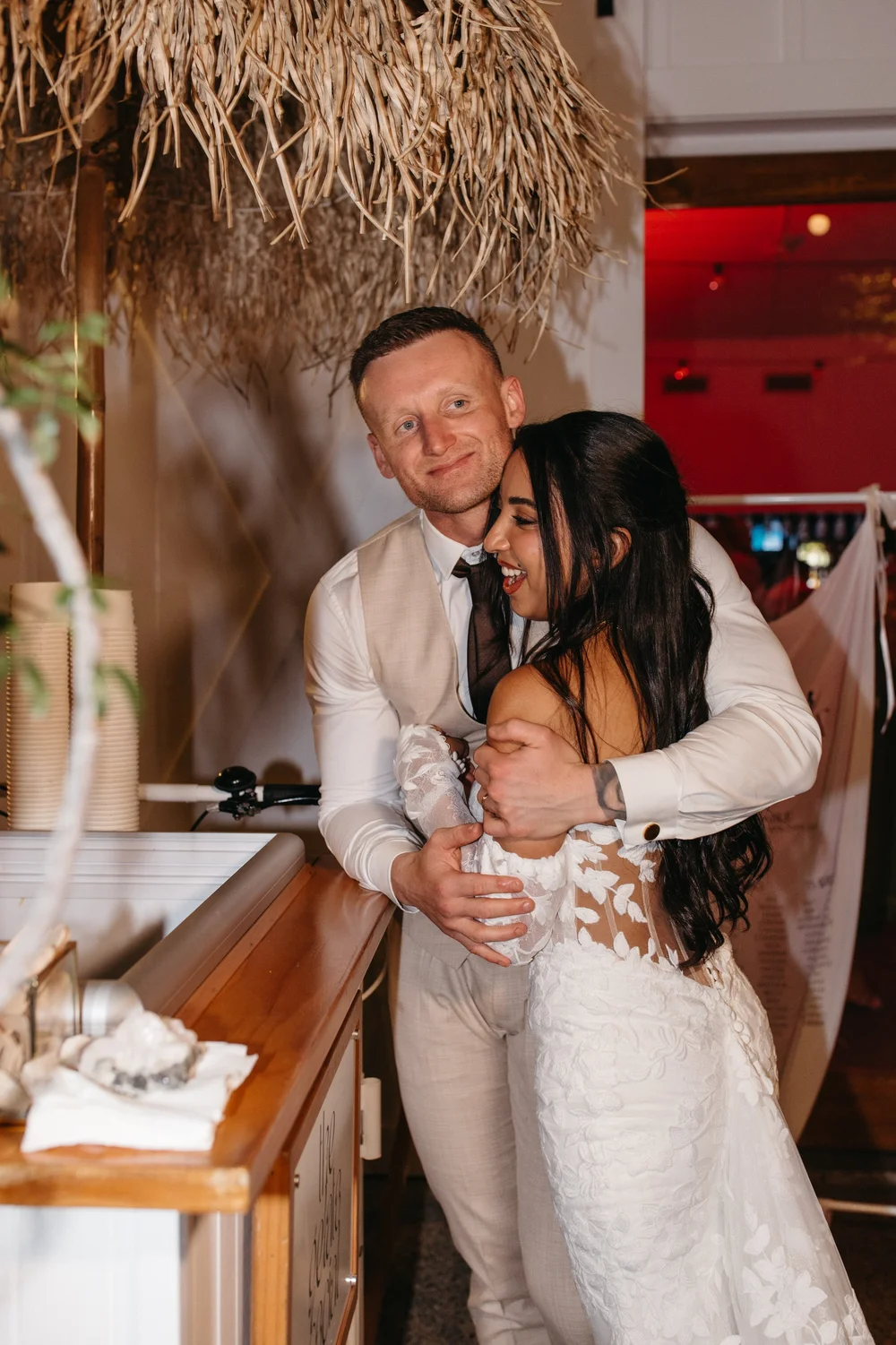 Newlyweds hugging beside the gelato cart